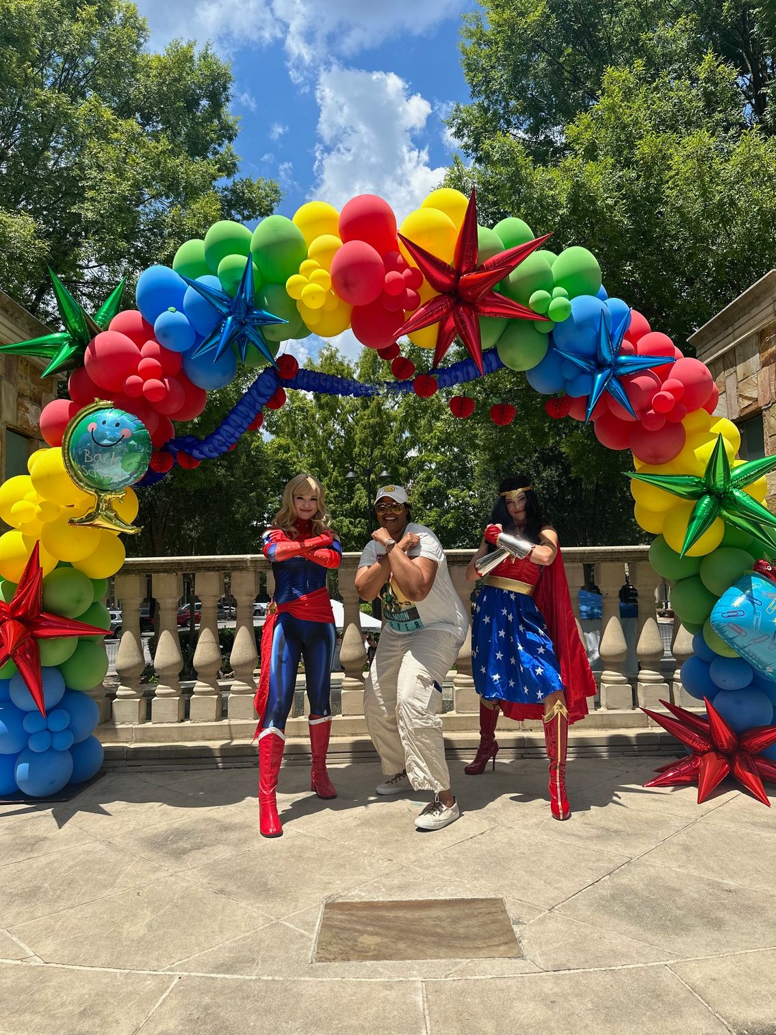Xtreme Dreams Foundation Back2School event with superhero characters under a balloon arch